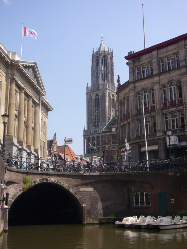 A canal in the old town of Utrecht with the Dom Tower rising above the houses